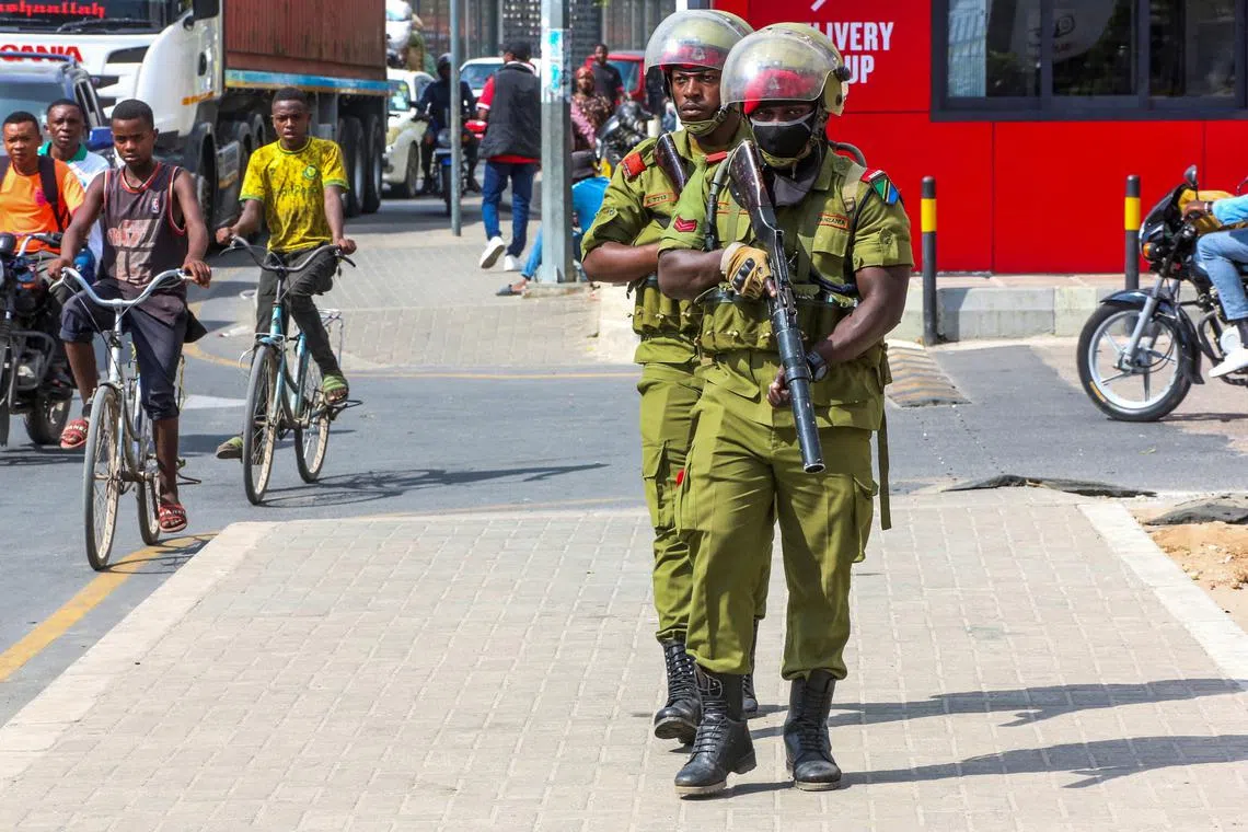 FILE PHOTO: Tanzania riot police officers walk during the protests to condemn a series of kidnappings and murders in Dar es Salaam, Tanzania, September 23, 2024. REUTERS/Emmanuel Herman/File Photo