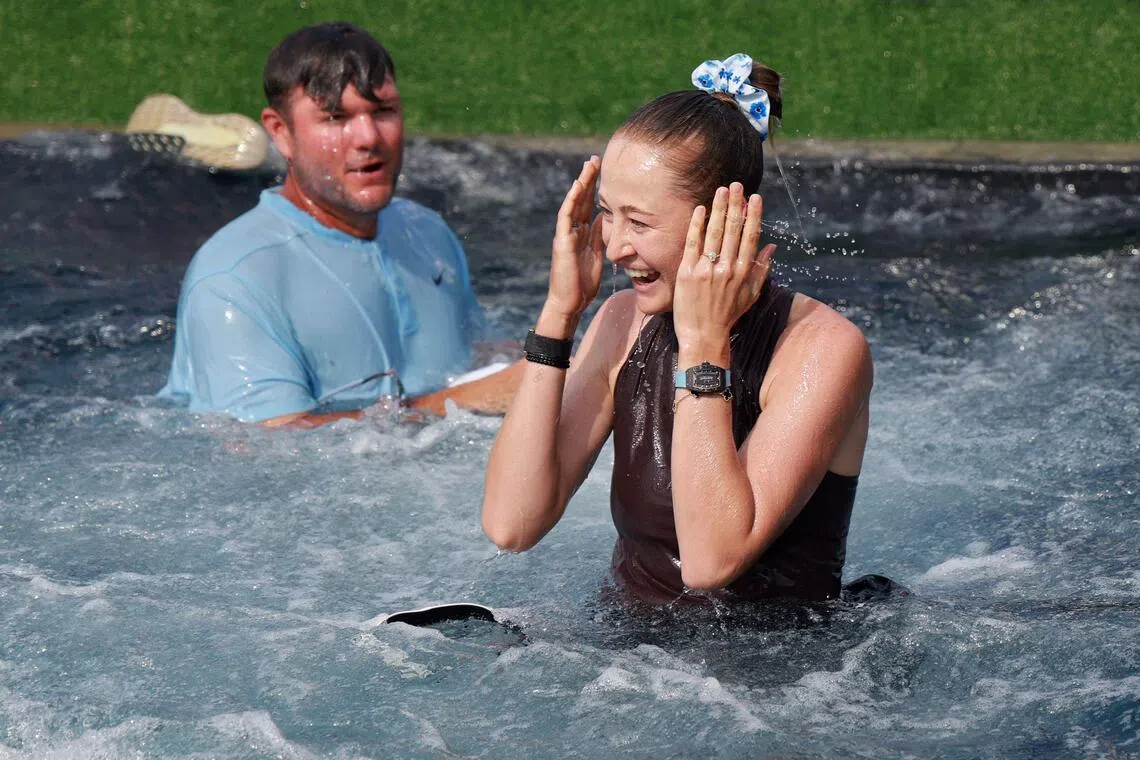 Nelly Korda of the United States and caddie Jason McDede react after jumping into Poppie's Pond after winning the 2026 Chevron Championship at Memorial Park Golf Course on April 26, 2026 in Houston, Texas.