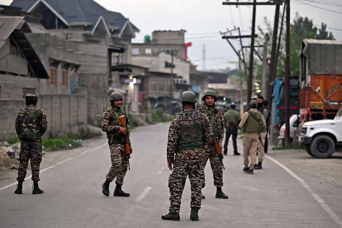 Indian security personnel stand guard in Wuyan near Srinagar on May 7, 2025, following border tensions. India and Pakistan exchanged heavy artillery along their contested frontier on May 7, after New Delhi launched missile strikes on its arch-rival in a major escalation between the nuclear-armed neighbours. New Delhi announced it had carried out "precision strikes at terrorist camps" at nine sites in Pakistan-administered Kashmir, days after it blamed Islamabad for a deadly attack on the Indian-run side of the disputed region. (Photo by Tauseef MUSTAFA / AFP)