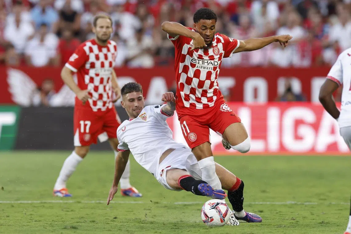 Sevilla's Jose Carmona tackling Girona's Arnaut Danjuma in their Spanish La Liga match at Ramon Sanchez-Pizjuan stadium on Sept 1, 2024.