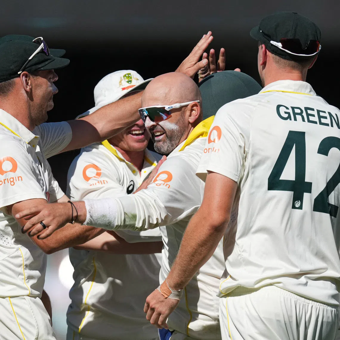 Cricket - The Ashes - Australia v England - Third Test - Adelaide Oval, Adelaide, Australia - December 20, 2025 Australia's Nathan Lyon celebrates with teammates after taking the wicket of England's Zak Crawley REUTERS/Asanka Brendon Ratnayake