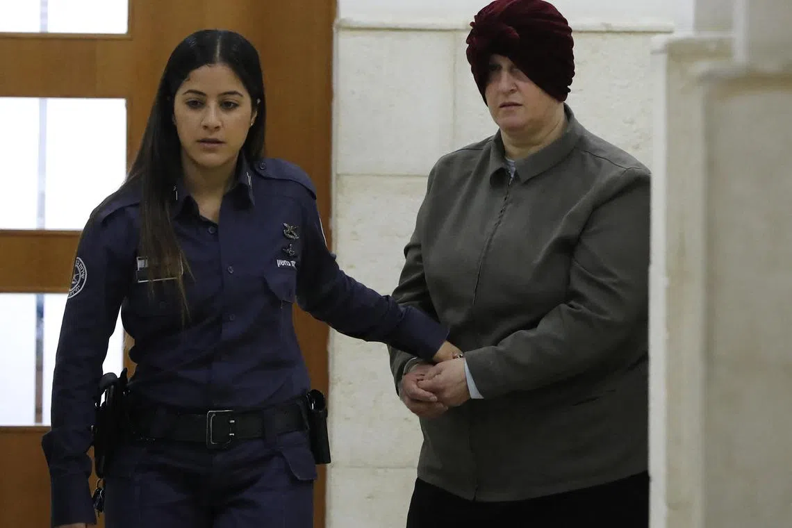 (FILES) Malka Leifer, a former Australian teacher accused of dozens of cases of sexual abuse of girls at a school, arrives for a hearing at the District Court in Jerusalem on February 27, 2018. An ex-headmistress who sexually abused two sisters at an Australian Jewish school, before fleeing to Israel then being extradited back, was sentenced on August 24, 2023 to 15 years in jail. Sentencing judge Mark Gamble said Malka Leifer abused her position within Melbourne's ultra-orthodox community and her "insidious offending" had scarred the sisters for life. (Photo by AHMAD GHARABLI / AFP)