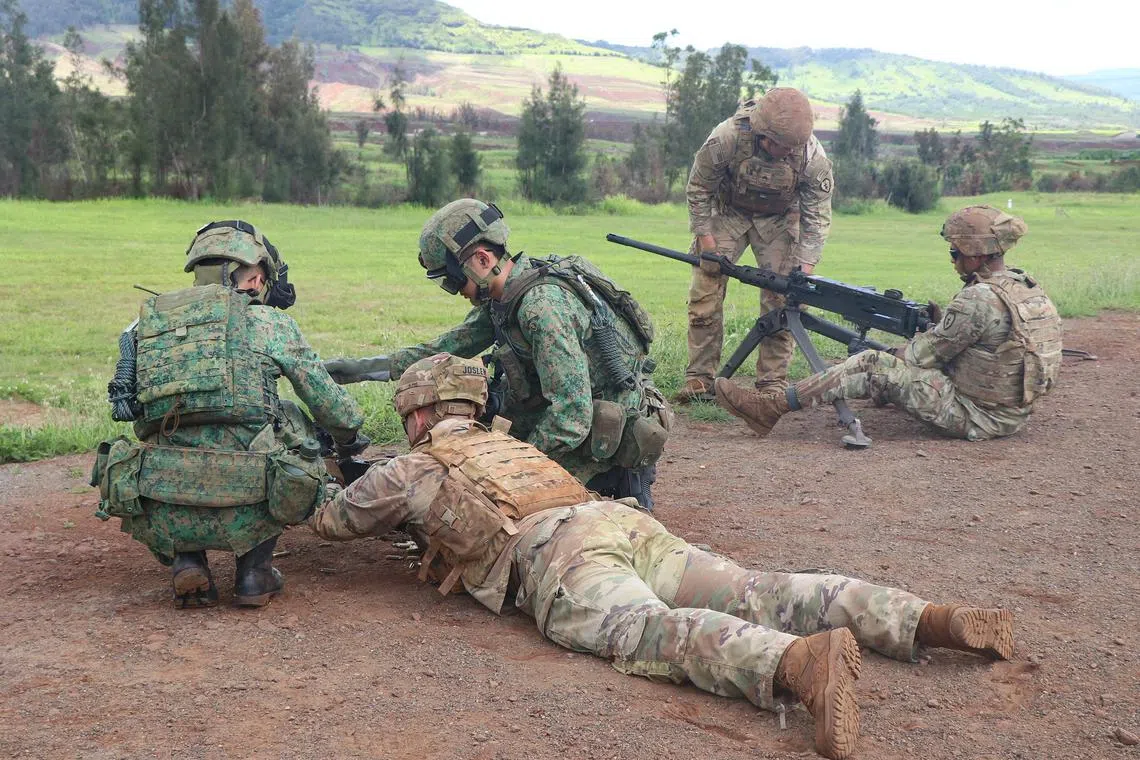 Soldiers from the Singapore Army and the US Army undergoing live-firing training during their weapons exchange session.