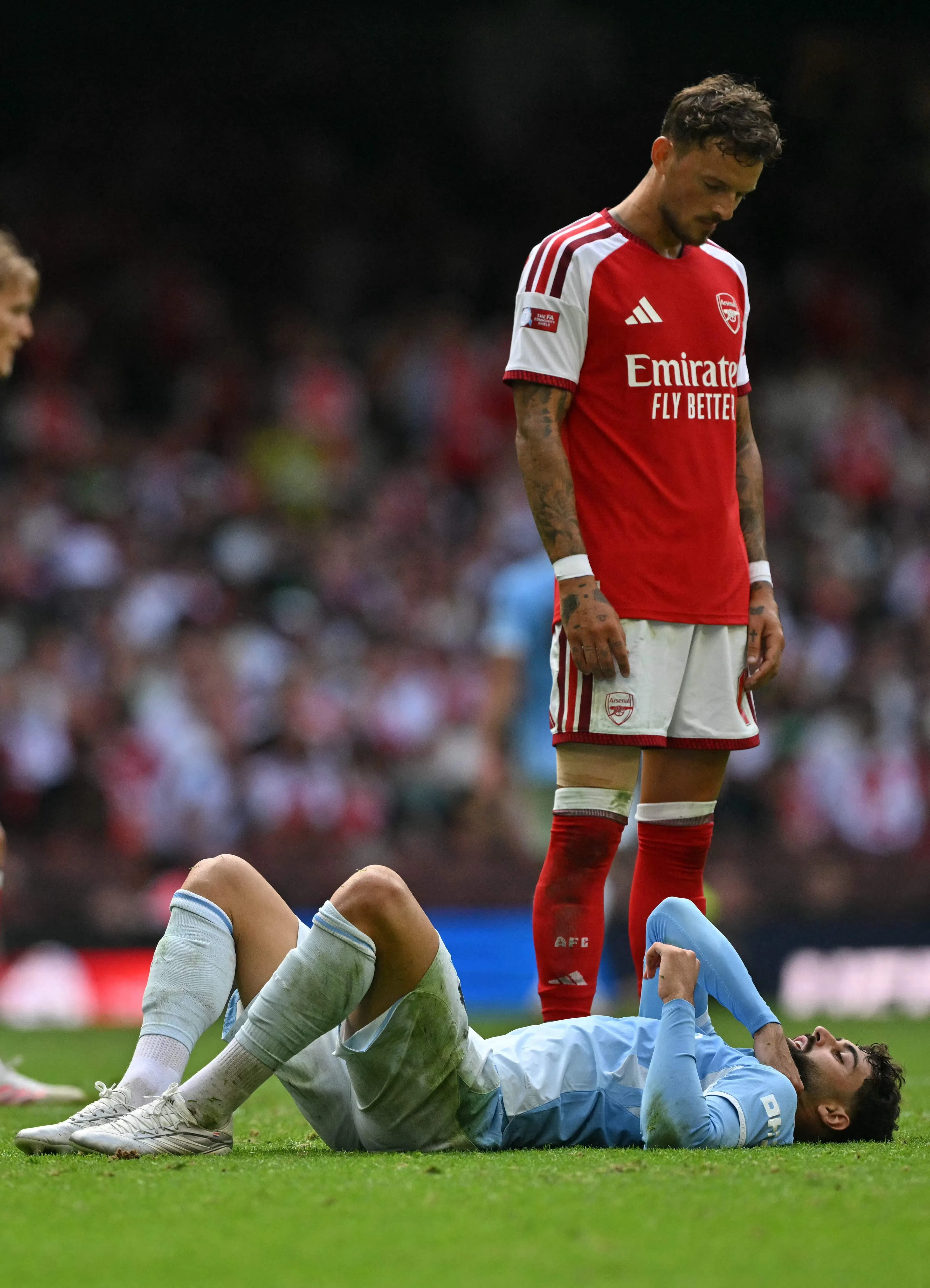 Arsenal defender Ben White standing over City defender Josko Gvardiol during the match.