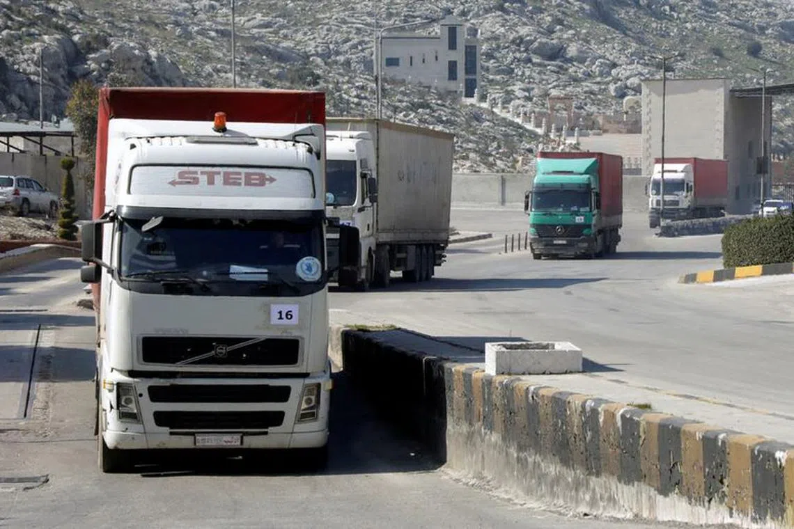 FILE PHOTO: A convoy of trucks carrying aid from UN World Food Programme (WFP), following a deadly earthquake, enters Bab al-Hawa crossing, Syria February 20, 2023.  REUTERS/Mahmoud Hassano/File Photo