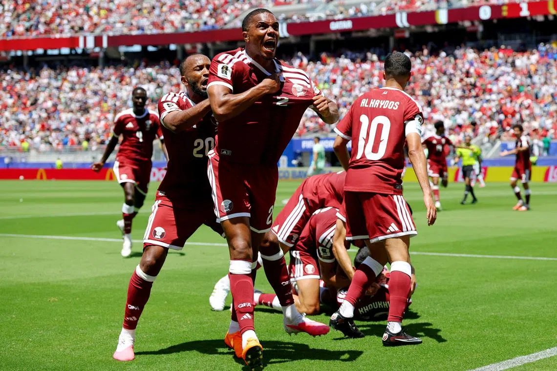 Soccer Football - FIFA World Cup 2026 - Group B - Qatar v Switzerland - San Francisco Bay Area Stadium, Santa Clara, California, U.S. - June 13, 2026 Qatar's Pedro Miguel and Ahmed Fathy celebrate after Boualem Khoukhi scored their first goal REUTERS/Carlos Barria