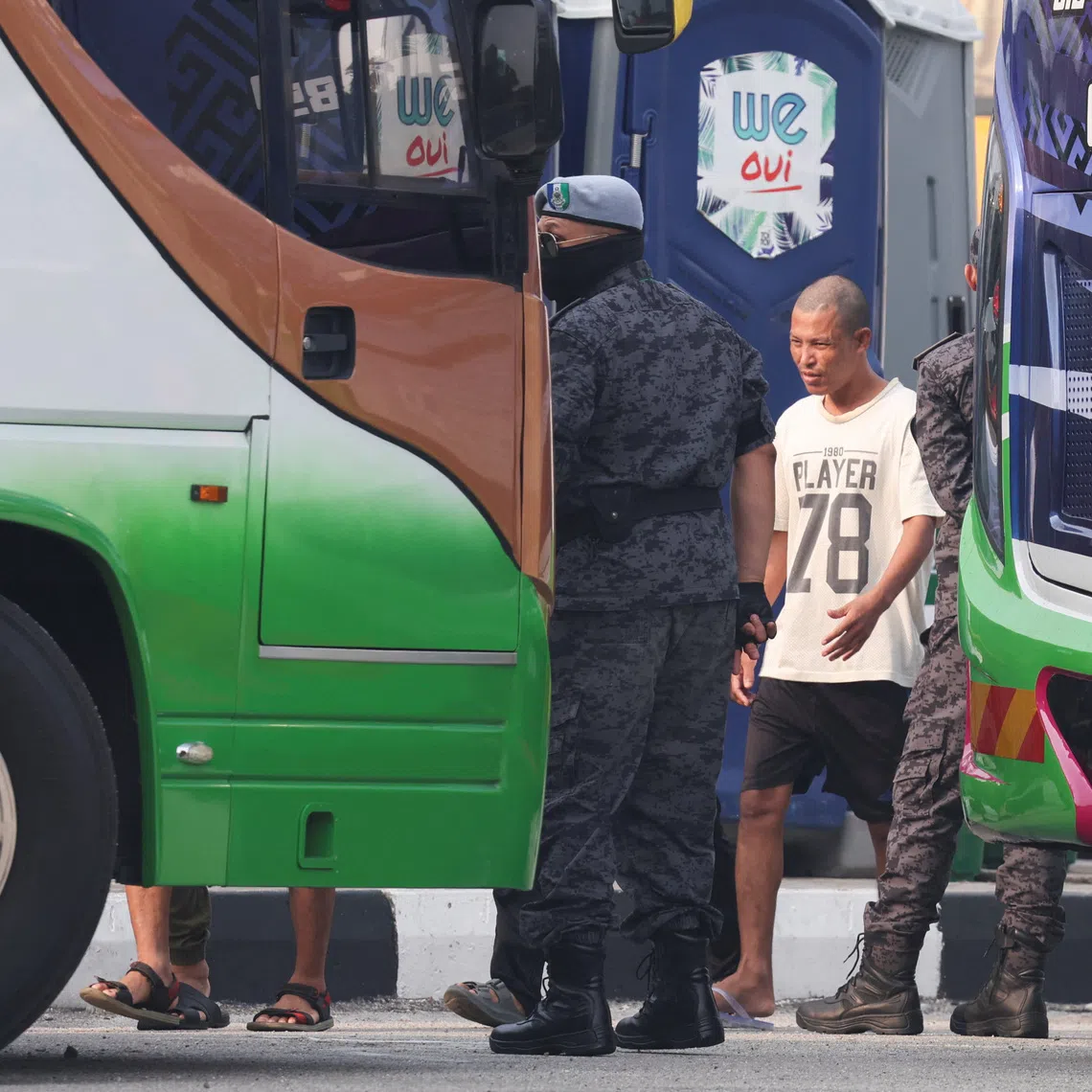 A Myanmar national due to be repatriated from Malaysia stands at Lumut, Malaysia, September 29, 2026. REUTERS/Hasnoor Hussain