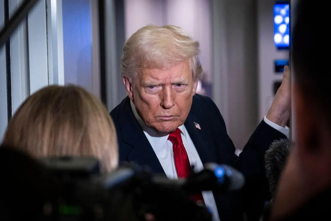 US President Donald Trump taking questions from the media aboard Air Force One on Nov 25, en route to Florida.