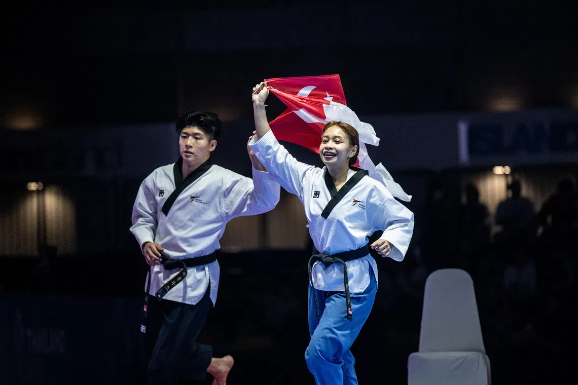 Nicholas Khaw and Diyanah Aqidah celebrate winning the gold medal.