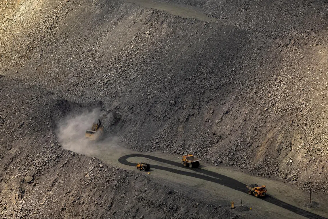 FILE PHOTO: An excavator digs as mining dump trucks drive in the Southern Iron Ore JV open-pit mine, amid Russia's attack on Ukraine, in Kryvyi Rih, Ukraine April 23, 2025.  REUTERS/Thomas Peter/File Photo