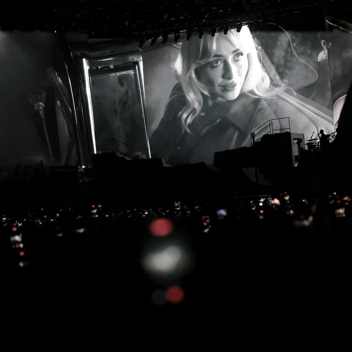 Sabrina Carpenter appears on the screen as she performs at the Coachella Valley Music and Arts Festival in Indio, California, U.S., April 10, 2026. 