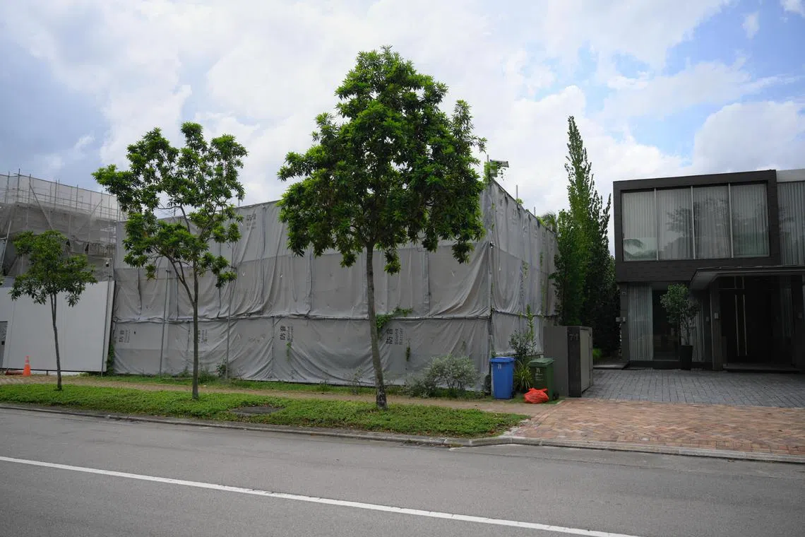 The plot of land (left, covered by sound barrier) at 69 Ocean Drive in Sentosa Cove which is up for sale, as seen on April 15.