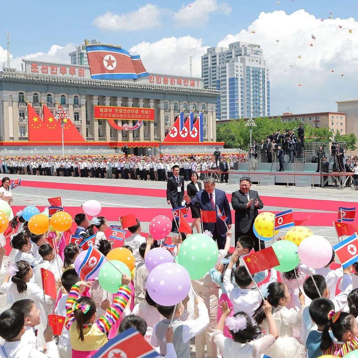 Chinese President Xi Jinping (left) and North Korean leader Kim Jong Un at a welcome ceremony for Xi in Pyongyang on June 8.