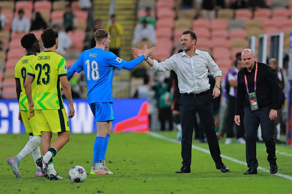 Soccer Football - World Cup - AFC Qualifiers - Group C - Saudi Arabia v Australia - King Abdullah Sports City Stadium, Jeddah, Saudi Arabia - June 10, 2025 Australia coach Tony Popovic celebrates with Joe Gauci after qualifying for the World Cup REUTERS/Stringer
