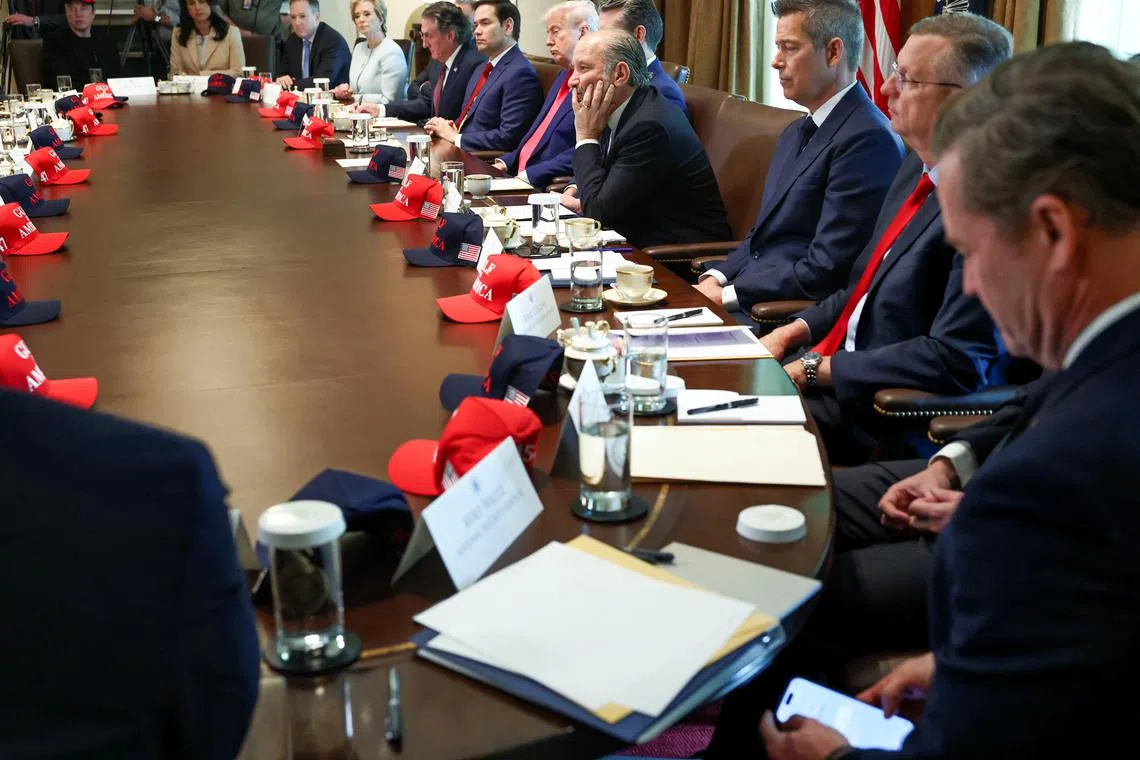 U.S. National Security Advisor Mike Waltz checks his mobile phone while attending a cabinet meeting held by U.S. President Donald Trump at the White House in Washington, D.C., U.S., April 30, 2025. REUTERS/Evelyn Hockstein