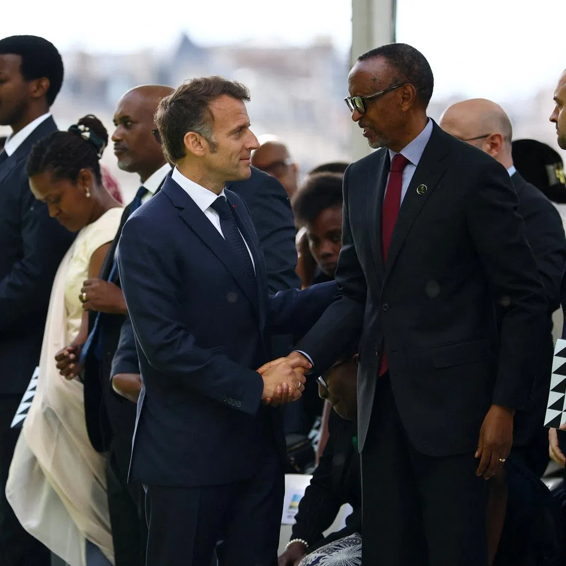 French President Emmanuel Macron shakes hands with Rwandan President Paul Kagame after the inauguration ceremony of a double stele artwork by artist Grada Kilomba, a new memorial site paying tribute to the victims of the Rwanda's genocide at the Habib-Bourgiba esplanade along the River Seine, in Paris, France, June 2, 2026. REUTERS/Sarah Meyssonnier/Pool