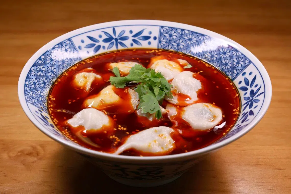 Fresh Chives With Pork Dumplings in Spicy Sour Soup Base at Chuxin Wonton.
