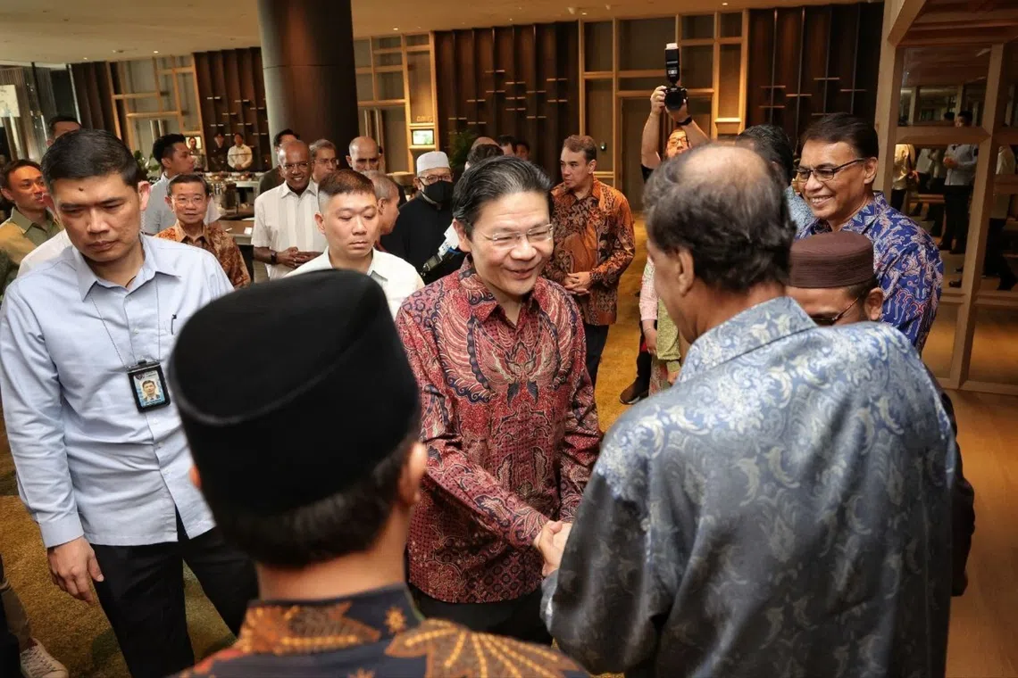 Prime Minister Lawrence Wong interacting with community leaders during the annual MHA Appreciation Lunch for community volunteers at Parkroyal Collection Marina Bay, on Sept 13.