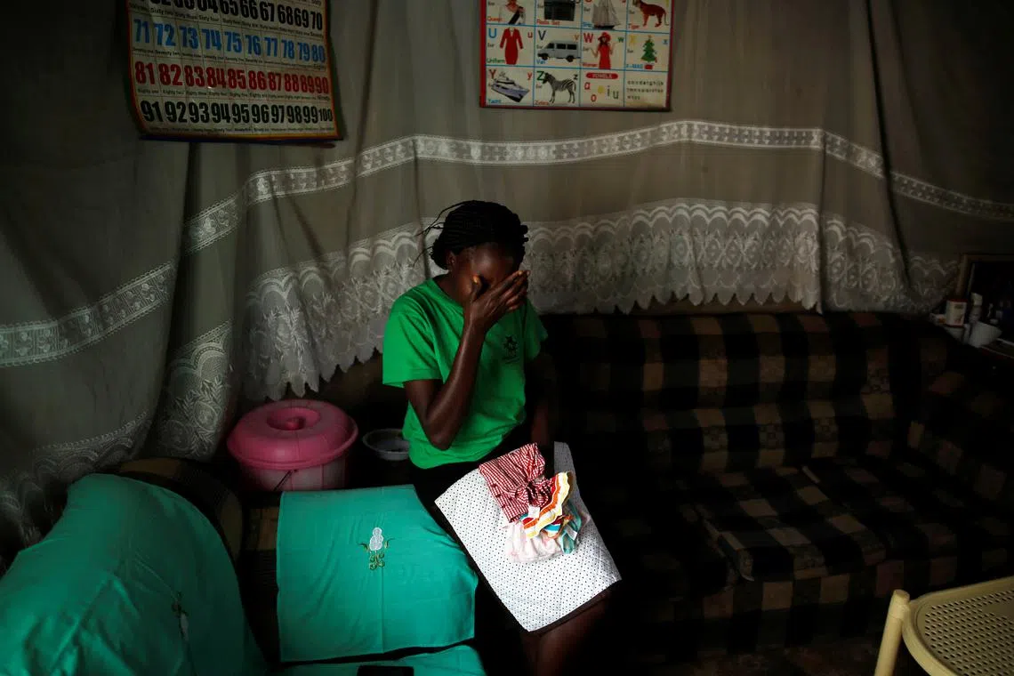 Lenzer Achieng, the mother of six-month-old Samantha Pendo who died during an August  2017 police crackdown on opposition supporters, holds her daughter's clothes inside her home, in the western city of Kisumu, Kenya, January 25, 2018. REUTERS/Baz Ratner/File Photo