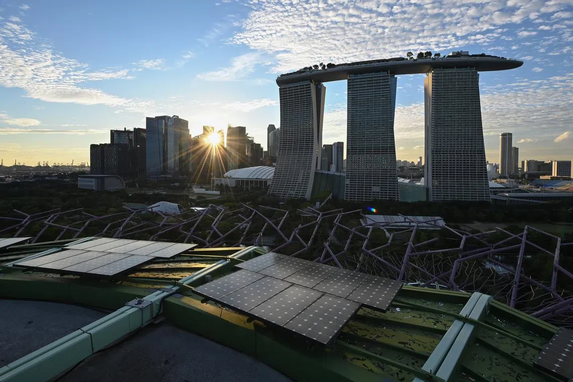 Marina Bay Sands hotel, Central Business District and Marina Bay Financial Centre taken from the rooftop deck of Supertree Observatory with solar panels, at Gardens by the Bay on Oct 11, 2021. Solar energy is touted as the most viable form of renewable energy for Singapore, but land constraints limit the installation of large solar farms and thus make decarbonising the country’s energy sources difficult.