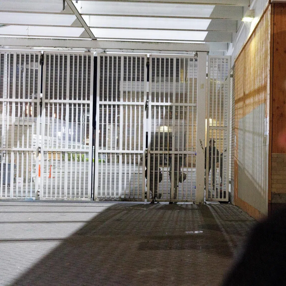 A person stands outside a US Immigration and Customs Enforcement (ICE) facility in Portland, Oregon, on Sept 27, 2025.