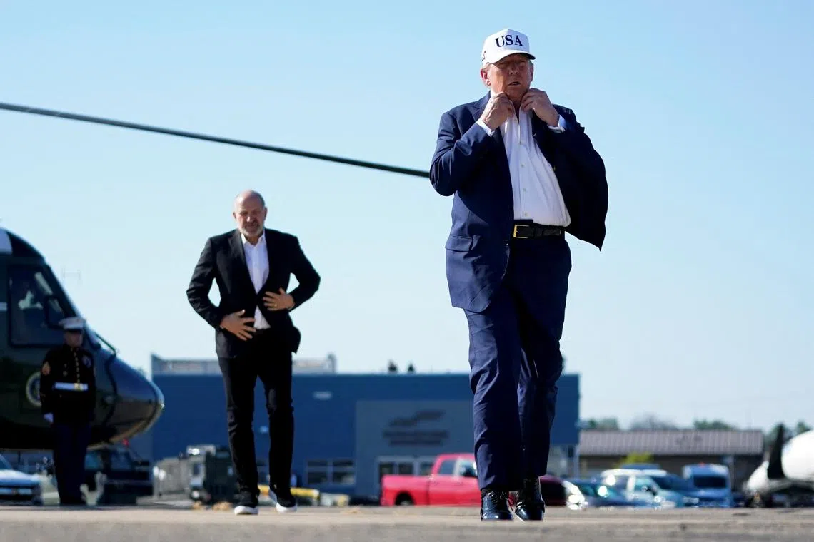 U.S. President Donald Trump and U.S. Secretary of Commerce Howard Lutnick, walk on the tarmac at Morristown Airport, in Morristown, New Jersey, U.S., July 6, 2025. REUTERS/Nathan Howard/File Photo