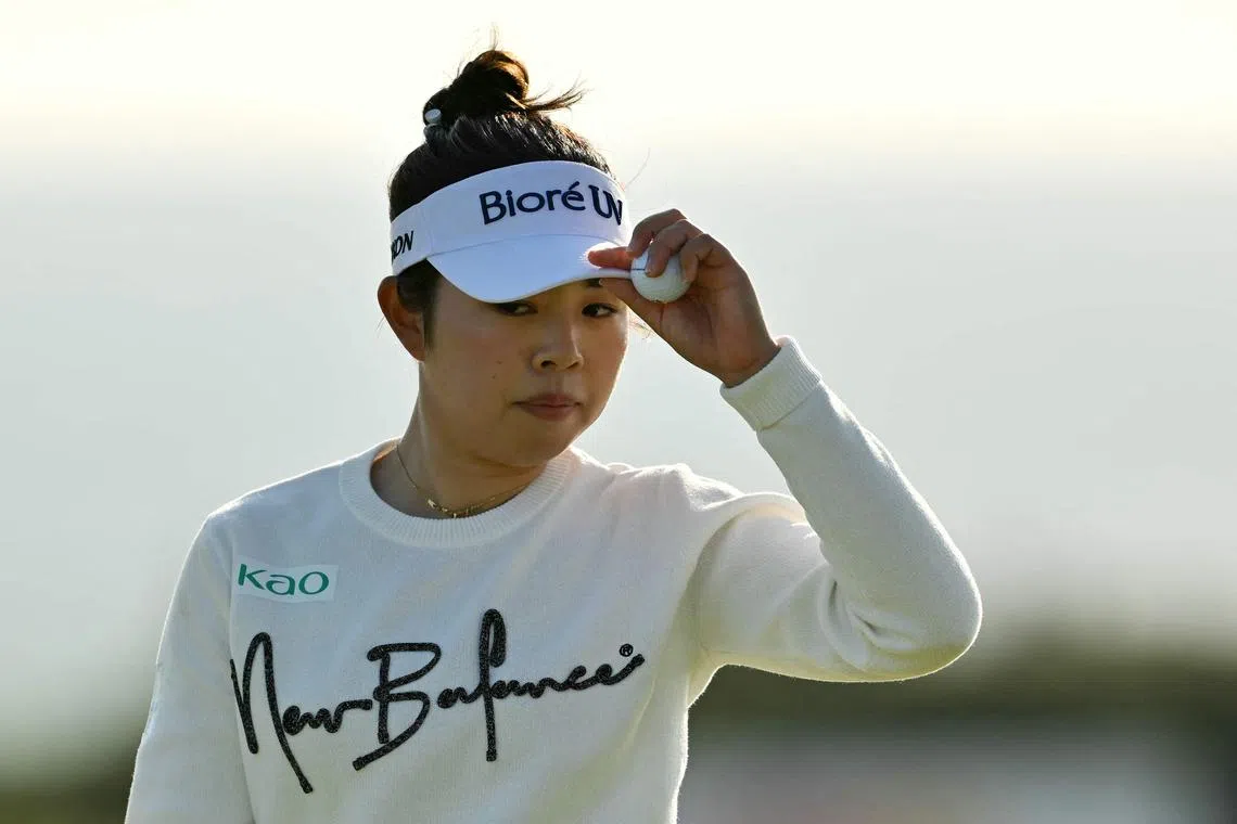 Leader Miyu Yamashita of Japan walking from the 18th green after putting out on day three of the Women's British Open golf championship at Royal Porthcawl in south Wales on August 2, 2025.