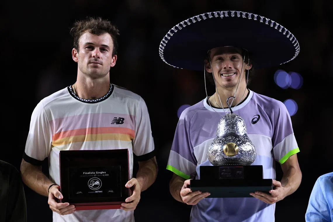 Australia's Alex de Minaur (right) after defeating American Tommy Paul to win the Mexican Open in Acapulco on March 4, 2023.