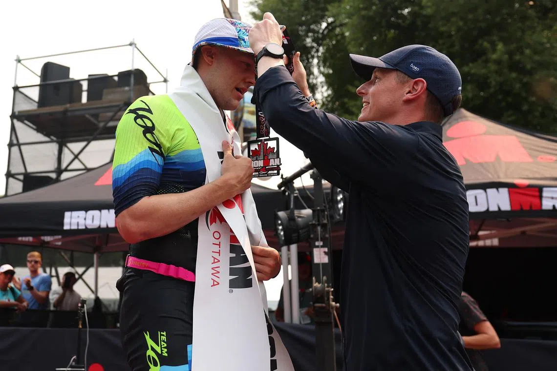 Luke Evans of Canada receives his medal after winning Ironman Canada-Ottawa on Aug 3, 2025 in Ottawa, Ontario.  