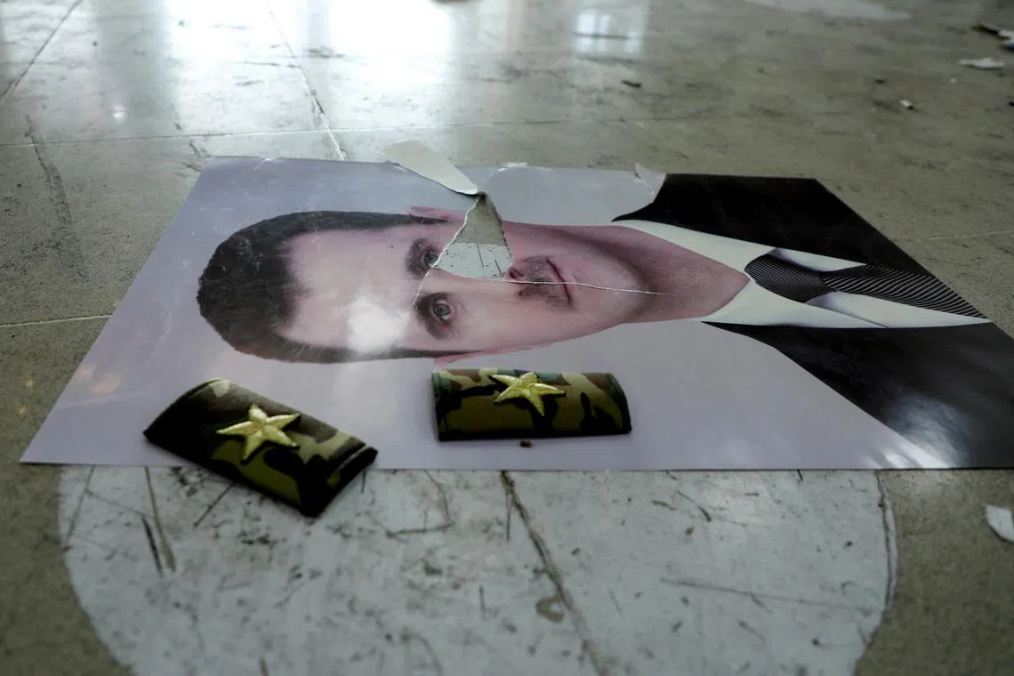 FILE PHOTO: A damaged picture of Syria's Bashar al-Assad lies on the floor inside Qamishli international airport, after Syrian rebels announced that they have ousted Syria's Bashar al-Assad, in Qamishli, Syria December 9, 2024. REUTERS/Orhan Qereman/File Photo