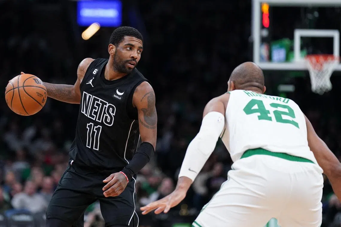 Brooklyn Nets guard Kyrie Irving, whose move to Dallas Mavericks has been confirmed, returning the ball against Boston Celtics center Al Horford at TD Garden. 