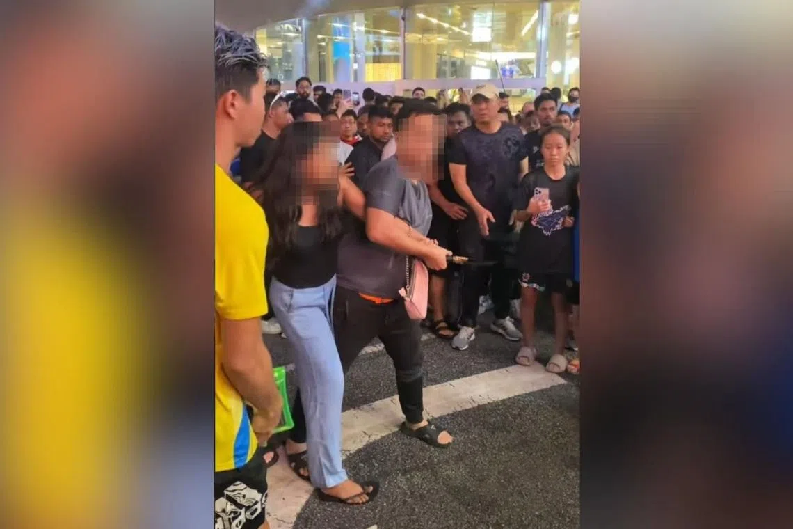 In a viral video, a man can be seen attempting to disarm the woman.