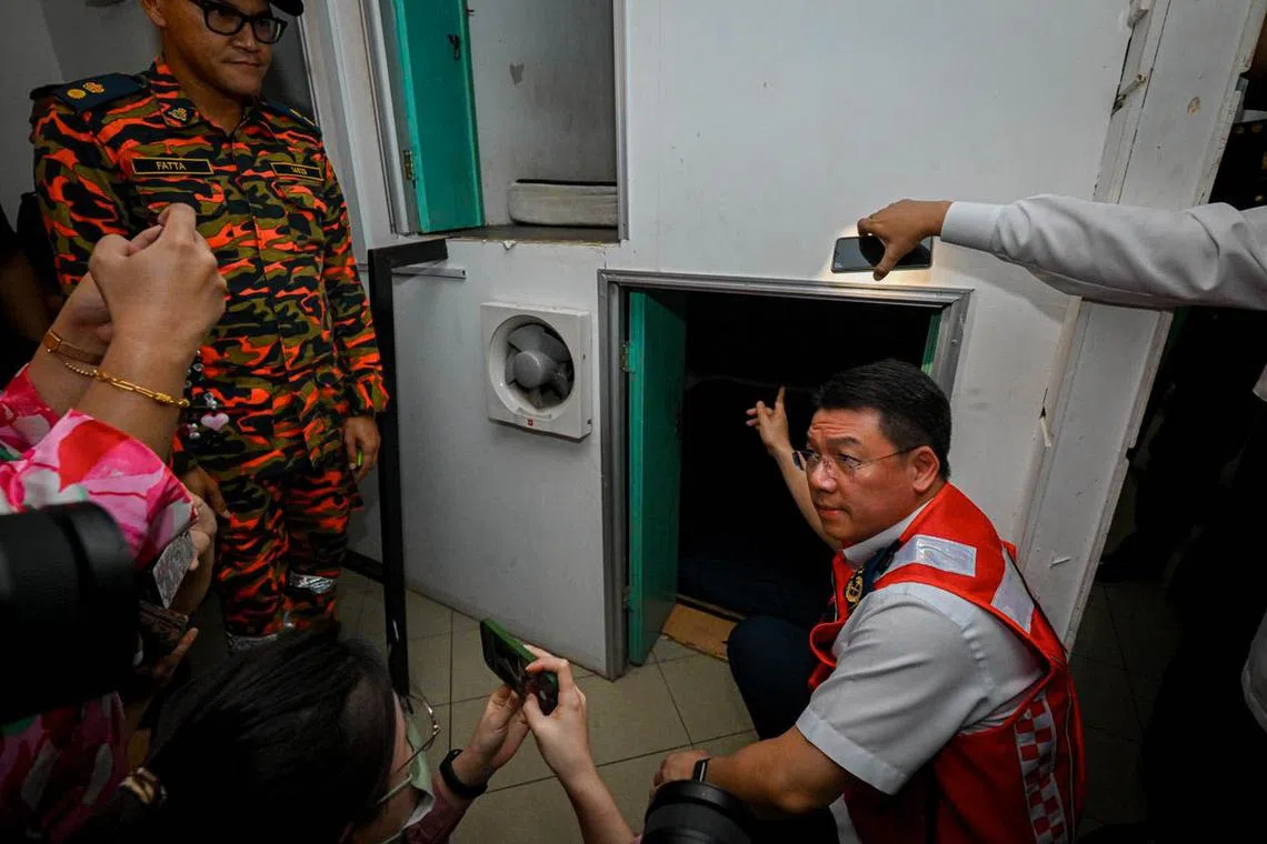 Mr Nga Kor Ming from Malaysia’s Local Government Development Ministry pointing out commercial premises that has been renovated into tiny rental rooms resembling “bird’s nests”. 
