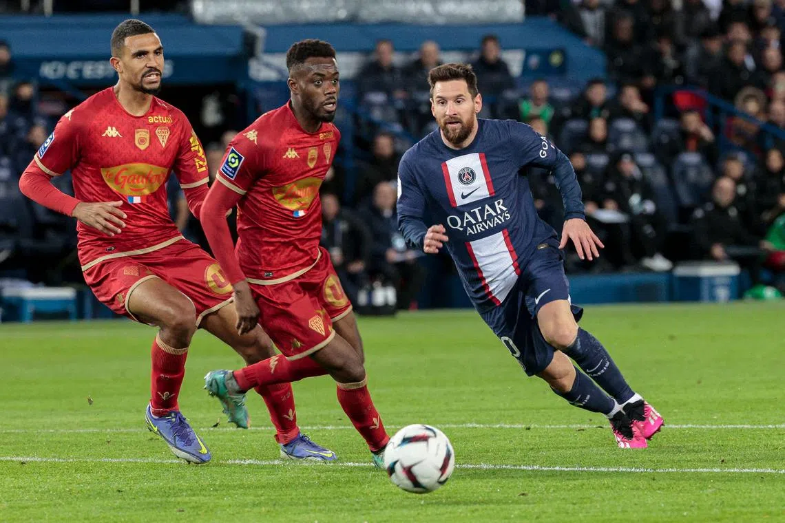 Paris Saint-Germain forward Lionel Messi fights for the ball with Angers defenders Abdoulaye Bamba (centre) and Cedric Hountondji during their Ligue 1 match.