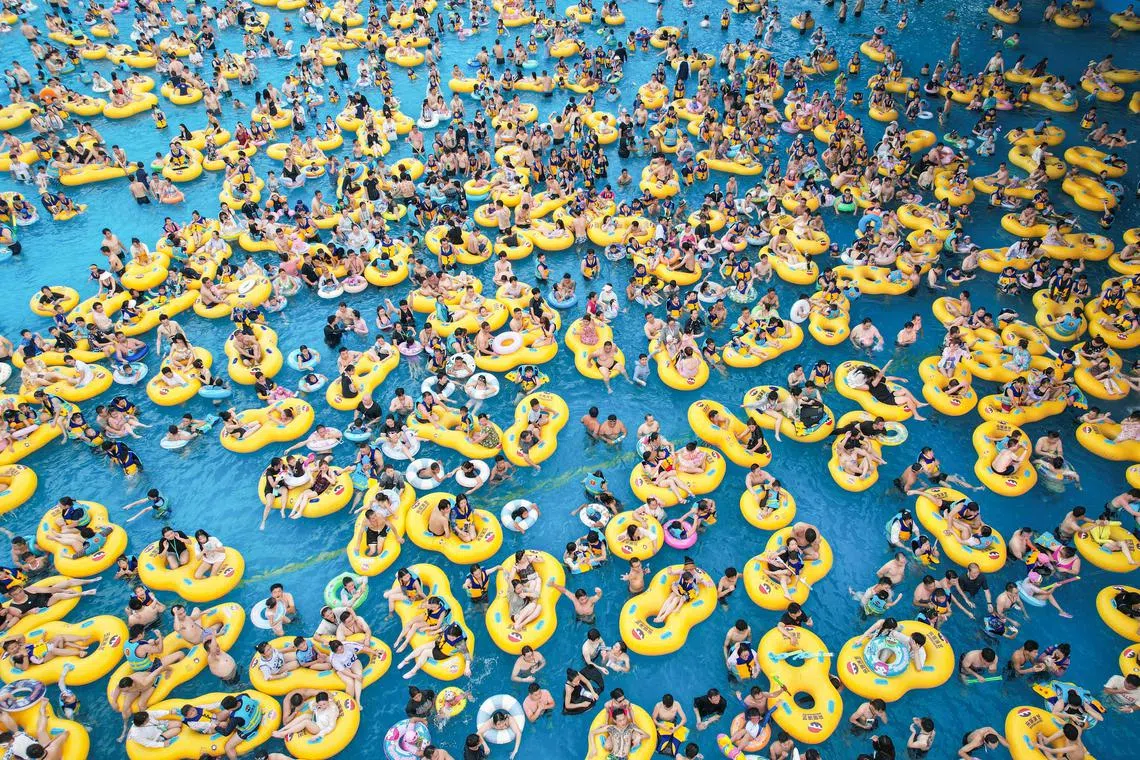 People cooling off at a water park in Hangzhou in China's eastern Zhejiang province, on July 21, 2024. 