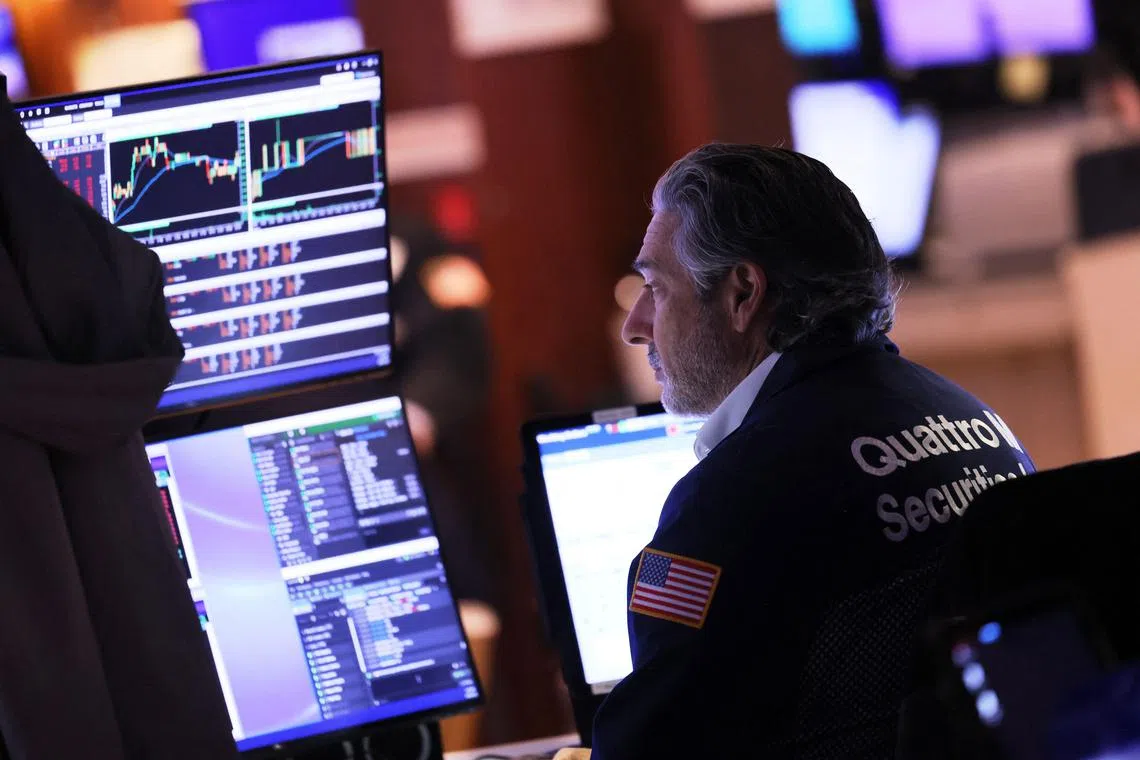 Traders work on the floor of the New York Stock Exchange, in New York City.