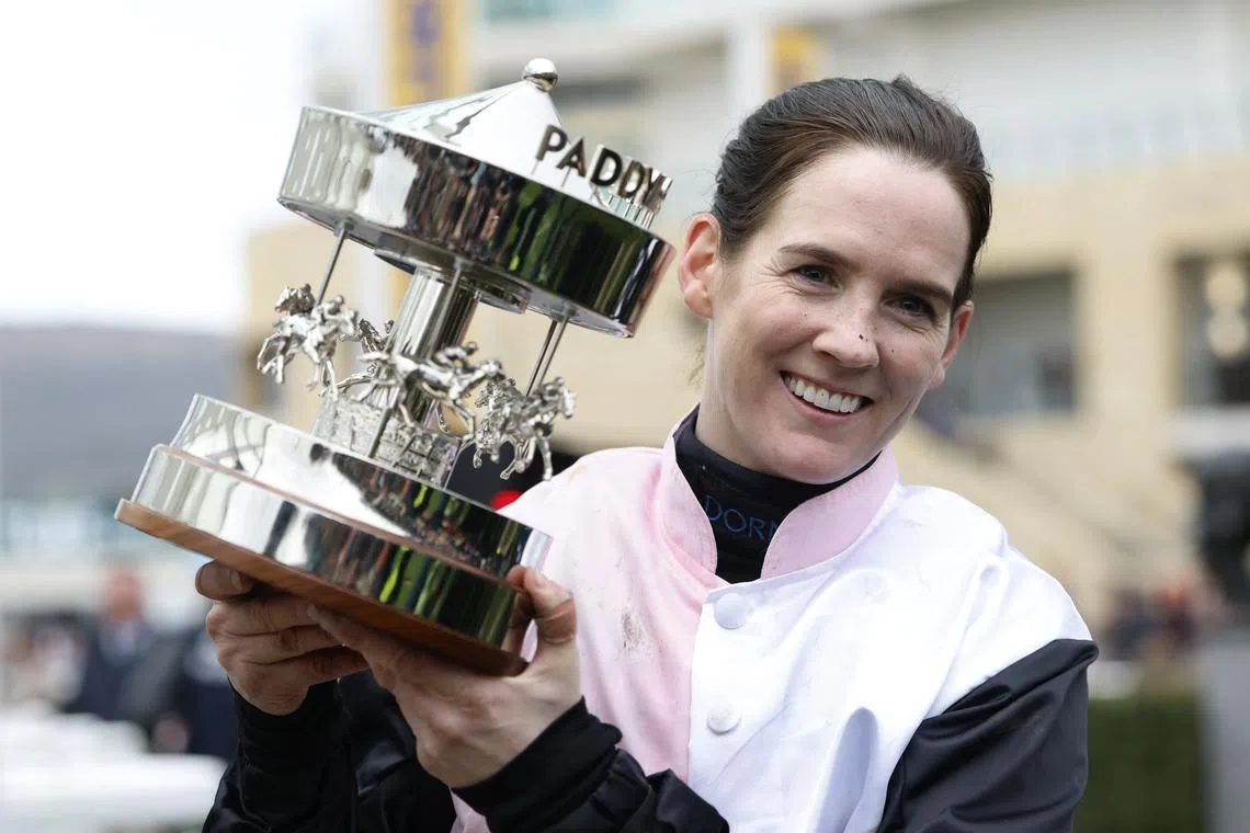 FILE PHOTO: Horse Racing - Cheltenham Festival - Cheltenham Racecourse, Cheltenham, Britain - March 13, 2025 Rachael Blackmore riding Bob Olinger celebrates with the trophy after winning the 16:00 Paddy Power Stayers' Hurdle REUTERS/Peter Cziborra/File Photo