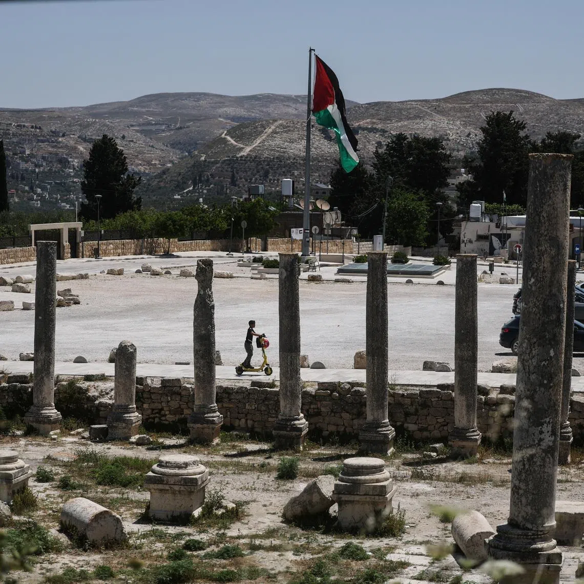 A Palestinian boy rides a scooter through archaeological remains in the ancient village of Sebastia, near Nablus in the Israeli-occupied West Bank, June 4, 2026. REUTERS/Ammar Awad