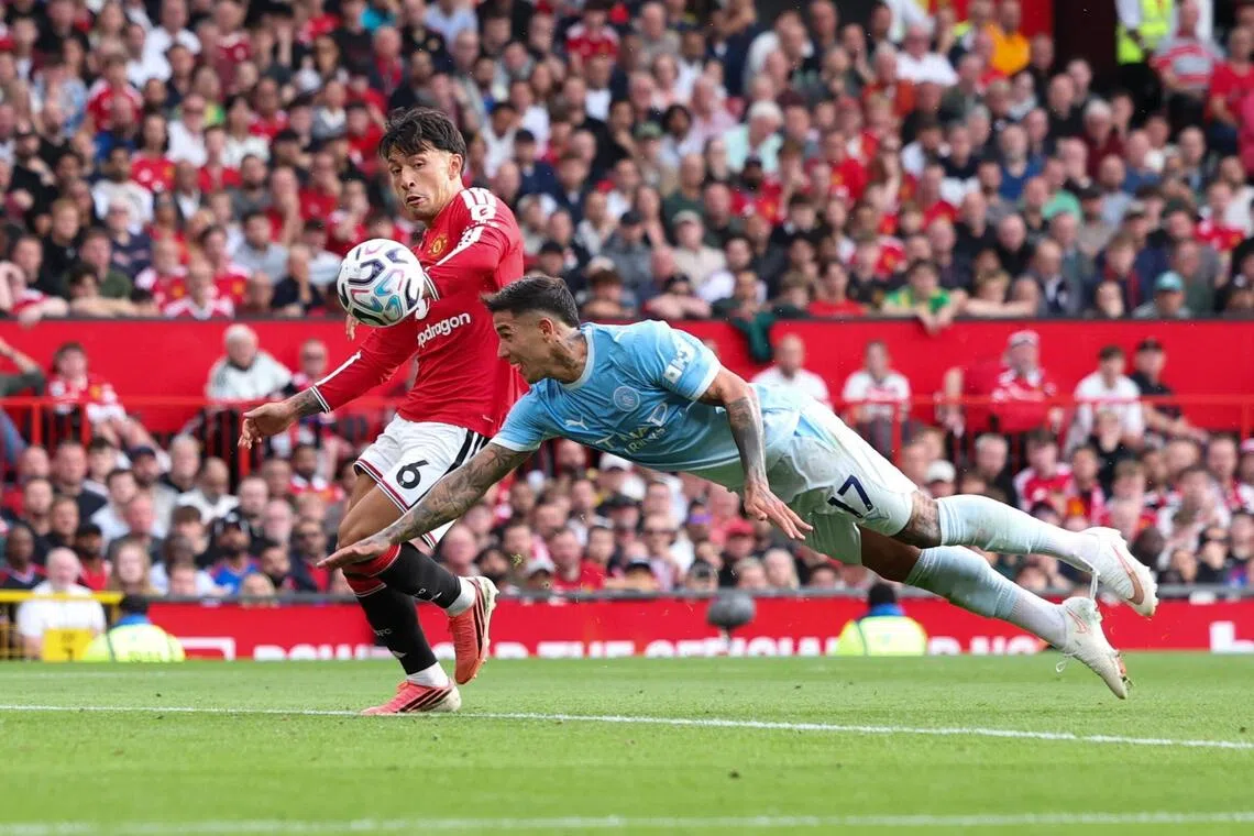 Manchester City’s Enzo Fernandez dives for the ball as Manchester United’s Lisandro Martinez defends, immediately before Erling Haaland scored City’s winner in their English Premier League game on Sept 13. The VAR failed to spot that Fernandez was clearly offside and interfering with play.