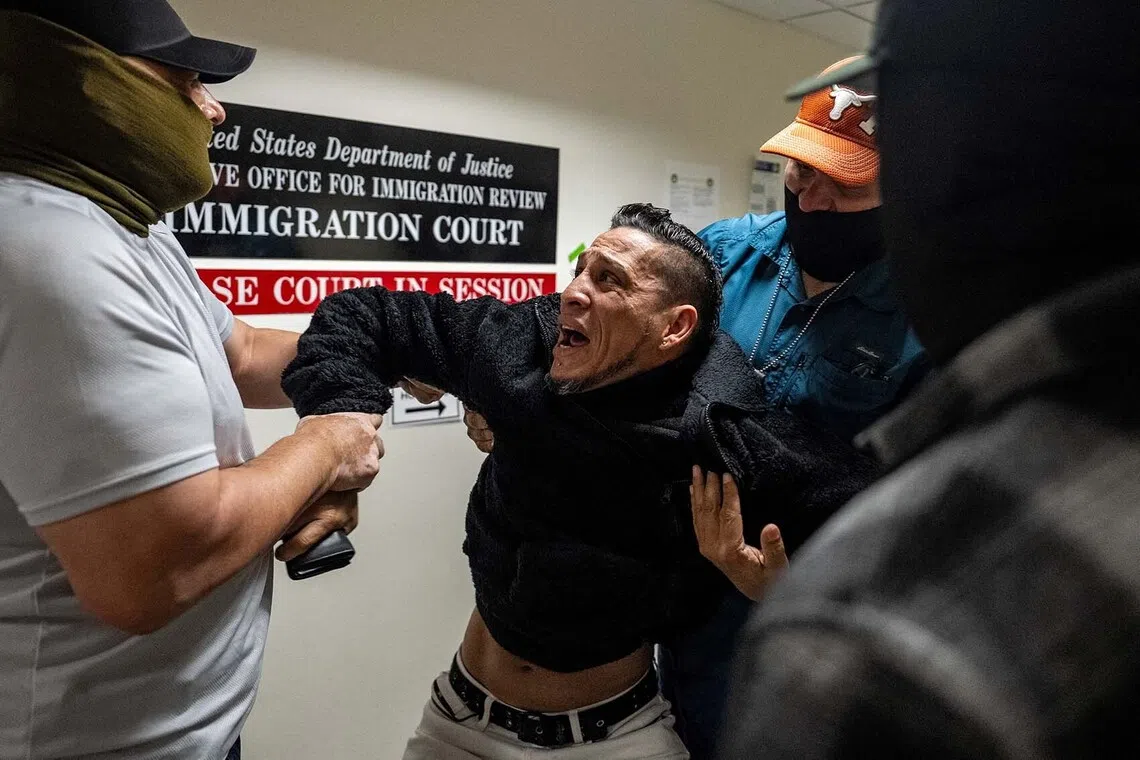 U.S. Immigration and Customs Enforcement (ICE) agents and federal officers detain a migrant as he walks out from a hearing during targeted detainment at a U.S. immigration court in Manhattan, in New York City, U.S., October 27, 2025. REUTERS/David 'Dee' Delgado TPX IMAGES OF THE DAY