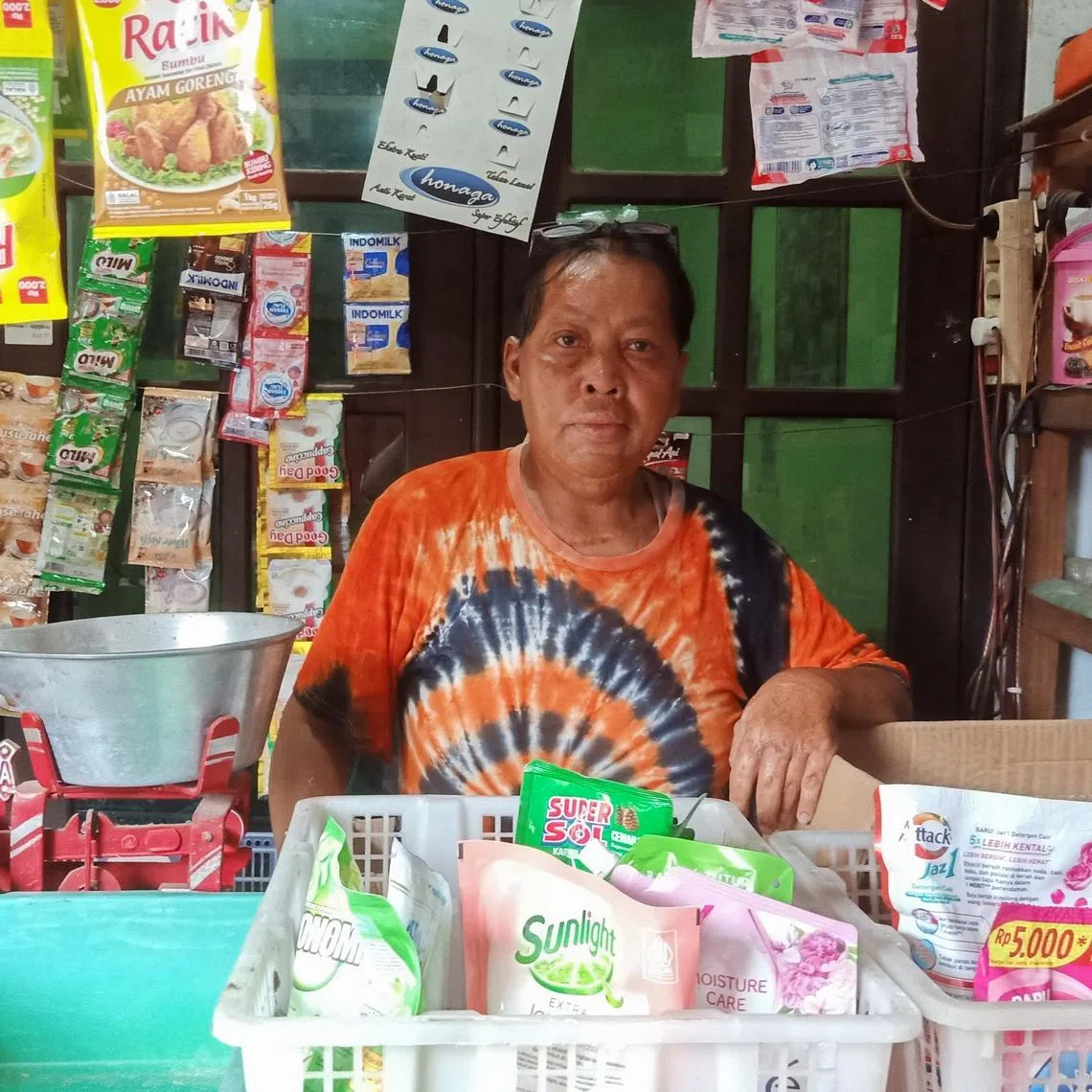 Chusnul Chotimah, 55, a survivor of the bombing in Bali in 2002, who has been relying on funds from Indonesia's victim and witness protection agency (LPSK) for medication and psychiatric assistance, poses for pictures inside his stall in Sidoarjo, East Java province, Indonesia, February 21, 2025. REUTERS/Prasto Wardoyo