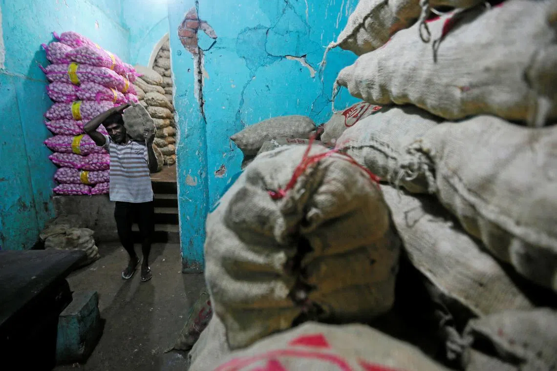 A worker carries a sack of imported potatoes near a main market in Colombo, Sri Lanka June 13, 2018. Picture taken June 13, 2018. REUTERS/Dinuka Liyanawatte/ File photo