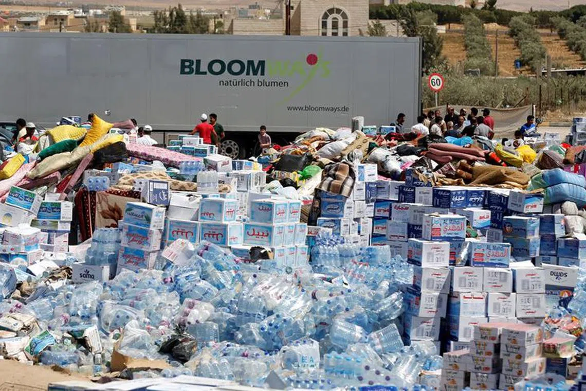 FILE PHOTO: Humanitarian aid is prepared to be delivered to Syria, in the town of Ramtha, Jordan, July 2, 2018. REUTERS/Muhammad Hamed/File Photo