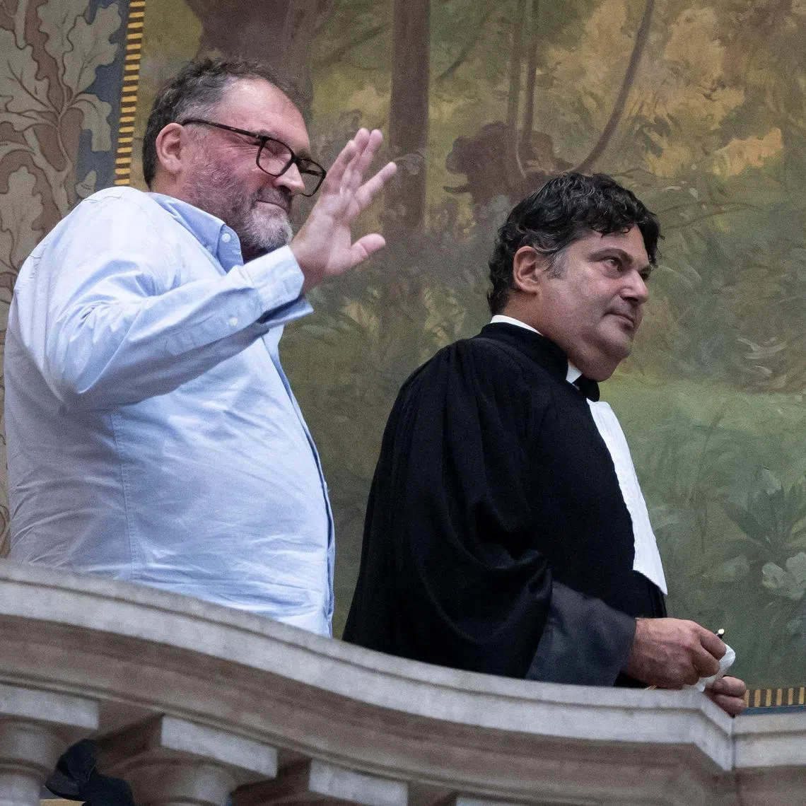 French former anaesthetist Frederic Pechier (L) reacts next to his lawyer Randall Schwerdorffer (R) during a break on the opening day of his trial, at Besancon's courthouse, in Besancon, north eastern France, on September 8, 2025. Frederic Pechier, 53, goes on trial on September 8, 2025, accused of intentionally poisoning 30 patients, 12 of whom died, in an alleged attempt to show off his resuscitation skills and discredit co-workers. (Photo by ROMEO BOETZLE / AFP)