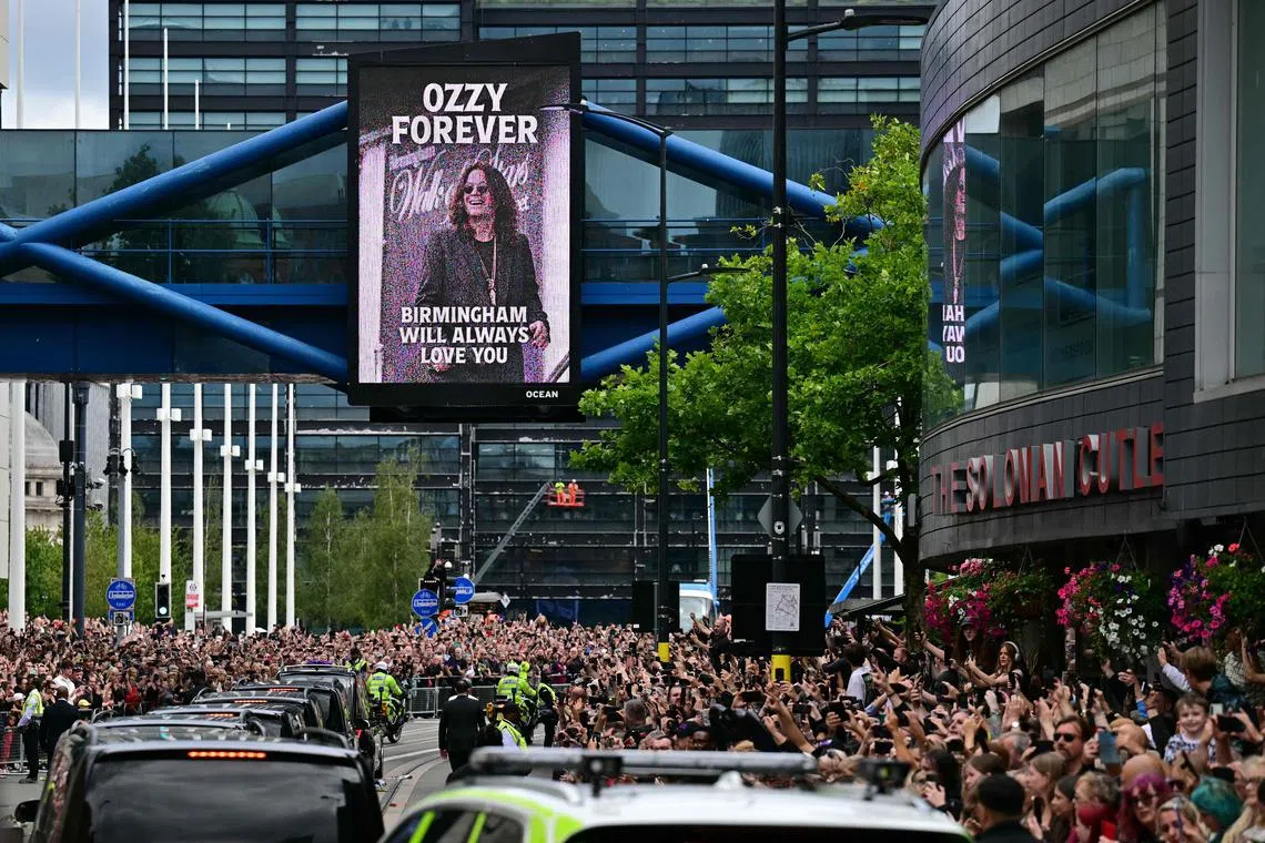 Mourners and music fans line the streets to pay their respects as the funeral cortege of late singer Ozzy Osbourne makes its way through Birmingham, central England on July 30, 2025.