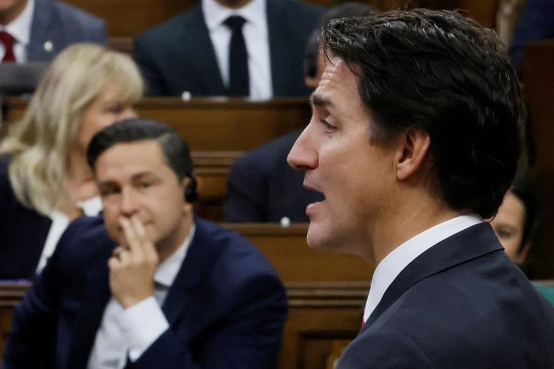 FILE PHOTO: Canada's Prime Minister Justin Trudeau speaks as Conservative Party of Canada leader Pierre Poilievre listens during Question Period in the House of Commons on Parliament Hill in Ottawa, Ontario, Canada September 18, 2023. REUTERS/Blair Gable/File Photo