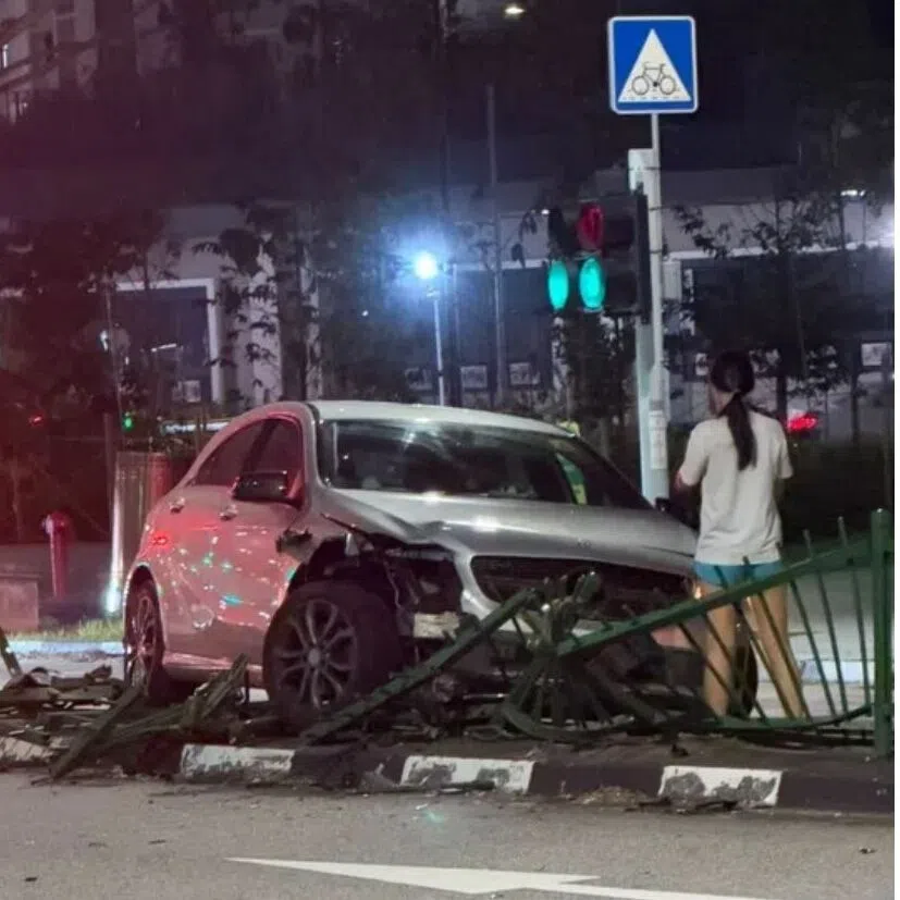 The front of the car looks damaged, while a section of the metal railing is twisted and flattened.