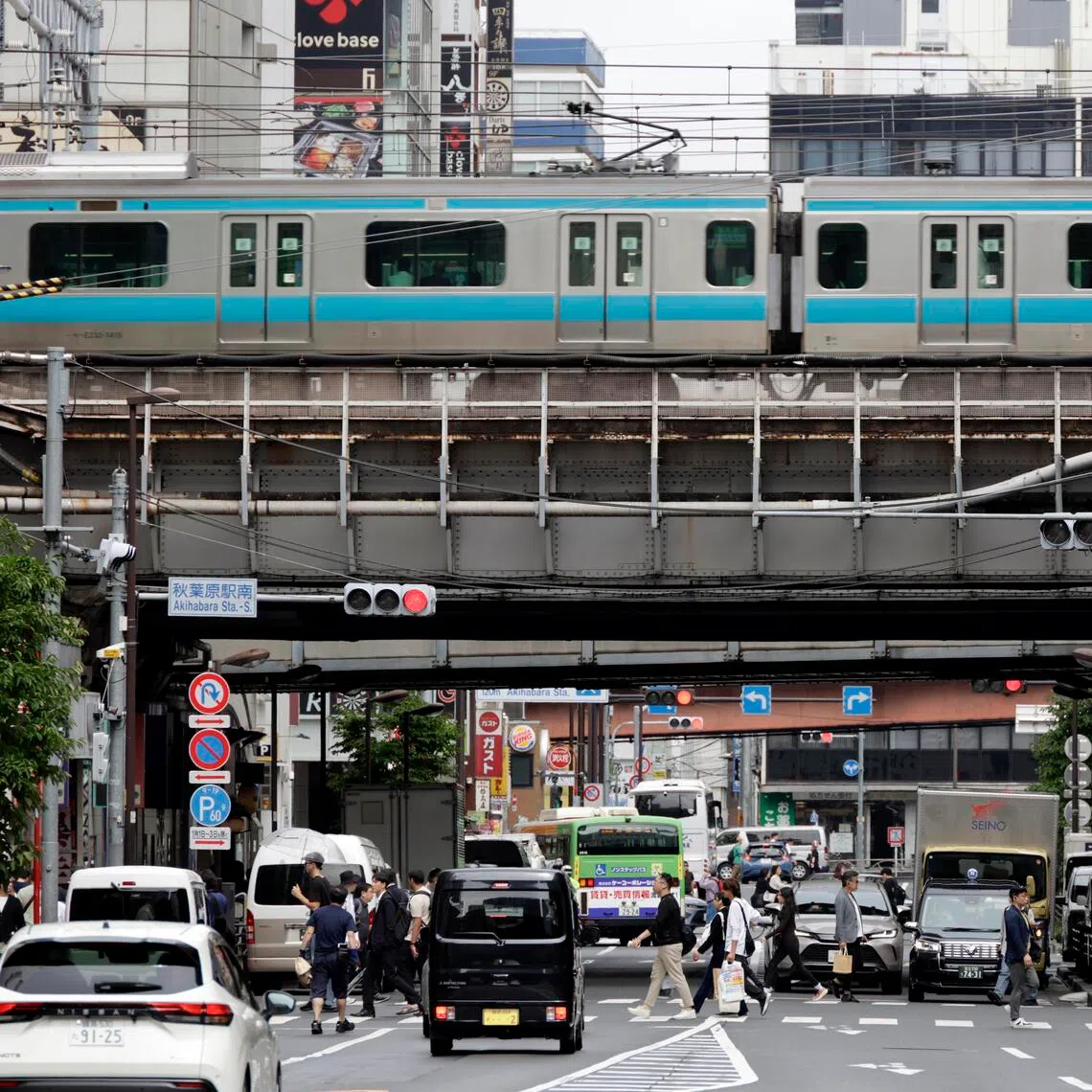 People cross a street in Akihabara in Tokyo, Japan, on June 8. 