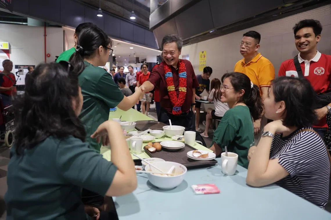 Presidential hopeful Tan Kin Lian interacts with residents at Our Tampines Hub during his walkabout on Aug 12.