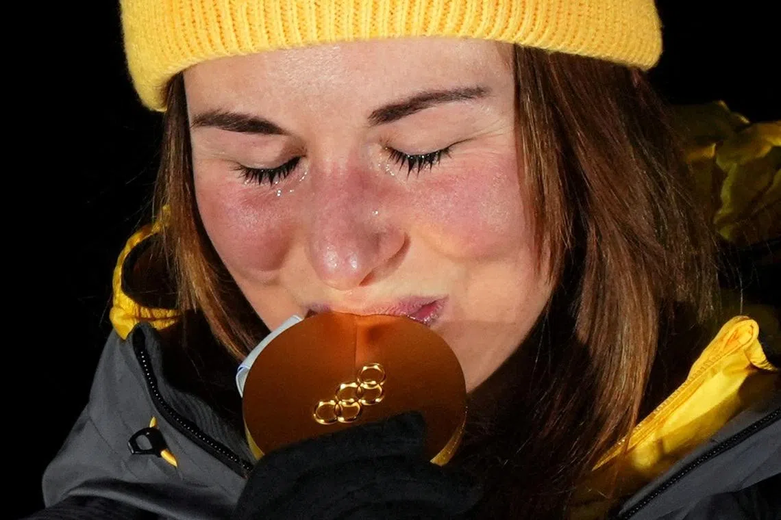 Milano Cortina 2026 Olympics - Luge - Women's Singles Victory Ceremony - Cortina Sliding Centre, Cortina d'Ampezzo, Italy - February 10, 2026. Gold medallist Julia Taubitz of Germany celebrates on the podium during the women's singles victory ceremony REUTERS/Aleksandra Szmigiel